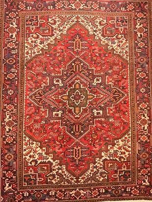 A close up of a red rug with a pattern on it.