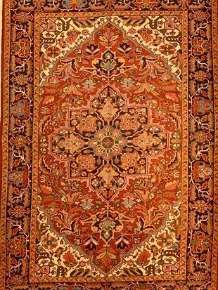 A close up of a rug with a floral pattern on it.