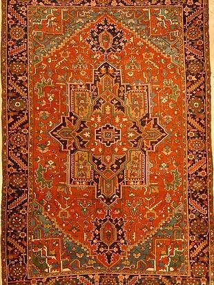 A close up of a rug with a floral pattern on it.