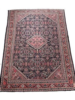 A rug with a pattern on it is sitting on a white surface.