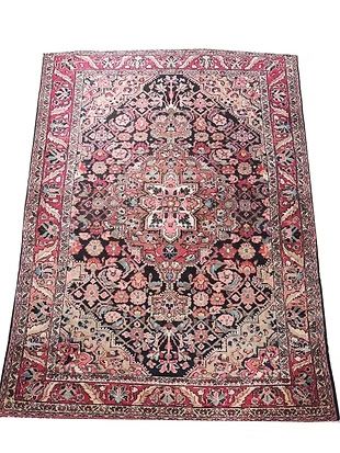 A rug with a floral pattern on it is on a white background.