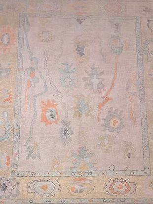 A close up of a rug with a floral pattern on it.