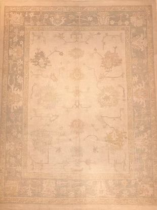 A white rug with a floral pattern on it is sitting on a table.