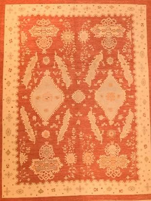 A red and white rug with a floral pattern on it