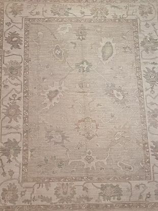 A close up of a rug with a floral pattern on it.