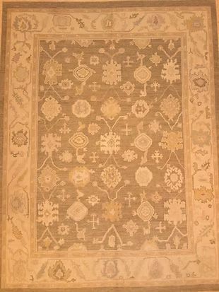 A rug with a floral pattern on it is on a table.