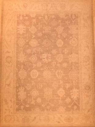 A rug with a floral pattern on it is sitting on a table.