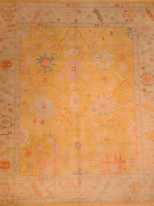 A yellow rug with a floral pattern on it is sitting on a table.