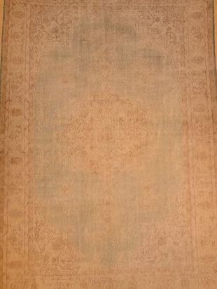 A close up of a brown rug with a pattern on it.