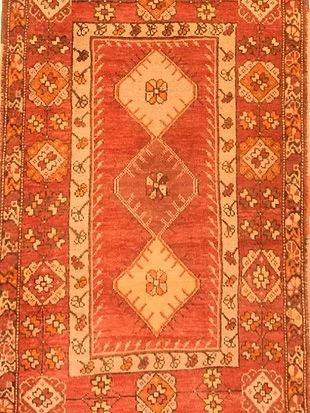 A red rug with a floral pattern on it
