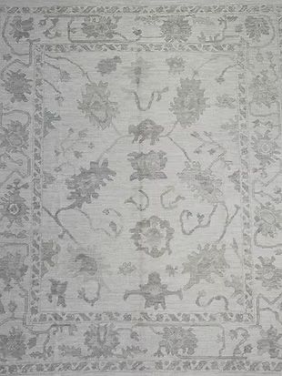 A close up of a rug with a floral pattern on it.