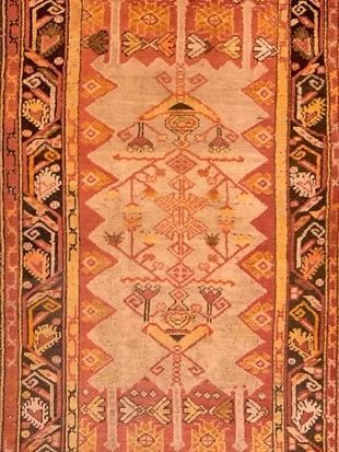 A close up of a rug with a geometric pattern