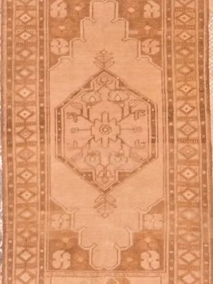 A brown rug with a geometric pattern on it