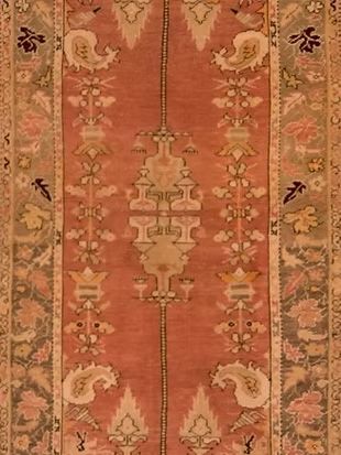 A close up of a rug with a floral pattern on it.