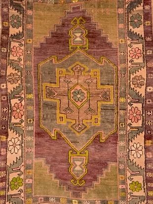 A close up of a rug with a floral pattern on it.