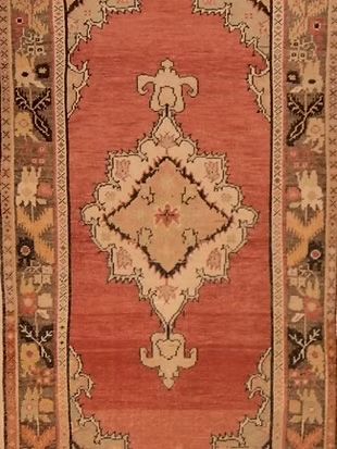 A close up of a rug with a floral pattern on it