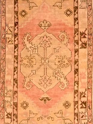 A close up of a rug with a pattern on it.