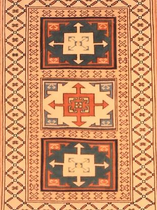 A rug with a pattern of squares and arrows on it