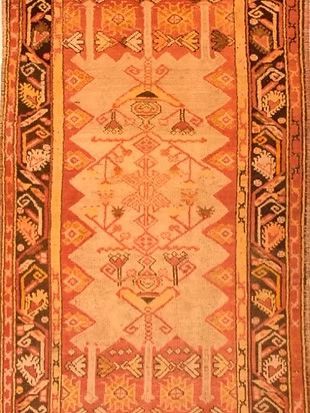 A close up of a rug with a geometric pattern on it