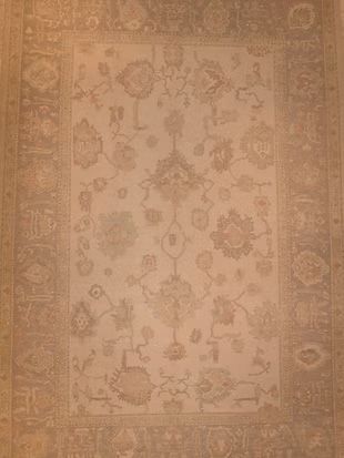 A rug with a floral pattern on it is sitting on a table.