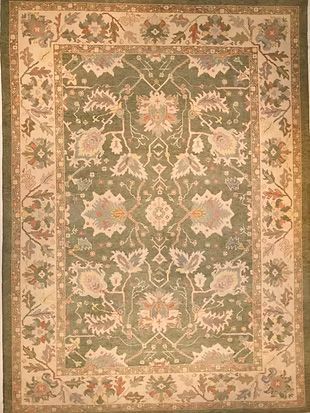 A green rug with a floral pattern on it