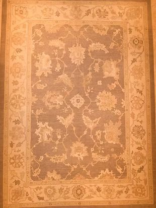 A rug with a floral pattern on it is sitting on a table.