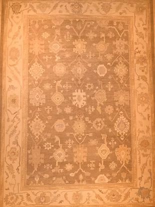 A rug with a floral pattern on it is sitting on a table.