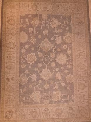 A rug with a floral pattern on it is sitting on a table.