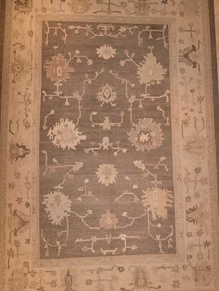 A rug with a floral pattern on it is sitting on a table.
