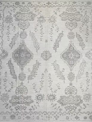 A white rug with a floral pattern on it.