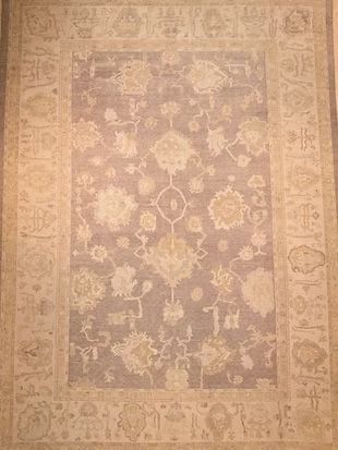 A rug with a floral pattern on it is sitting on a table.