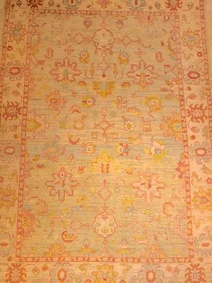 A close up of a rug with a floral pattern on it.