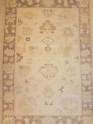 A rug with a floral pattern on it is sitting on a table.