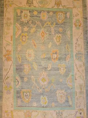 A rug with a floral pattern on it is sitting on a table.