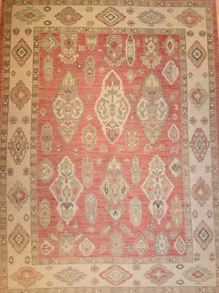 A red and white rug with a pattern on it is sitting on a table.