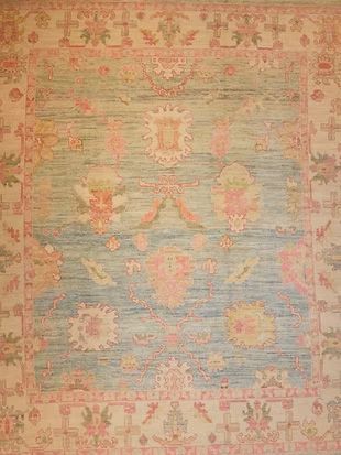 A rug with a floral pattern on it is on a wall.