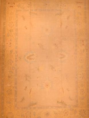 A close up of a brown rug with a pattern on it.