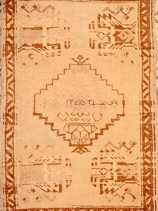 A close up of a rug with arabic writing on it