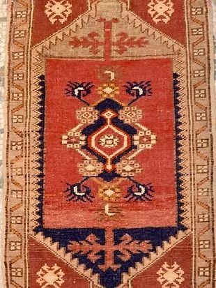 A red and blue rug with a geometric pattern on it.