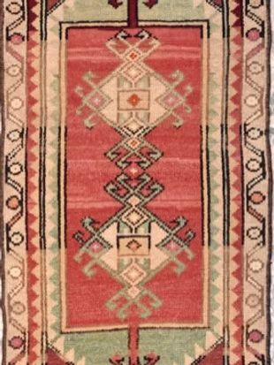 A red rug with a geometric pattern on it