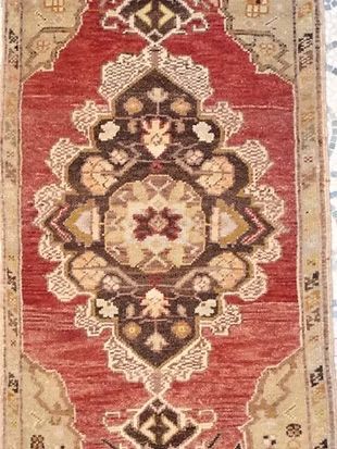 A close up of a rug with a floral pattern on it.