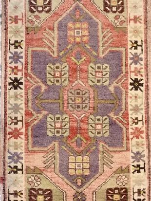 A close up of a rug with a pattern on it.