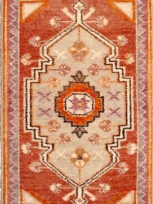 A close up of a rug with a geometric pattern on it