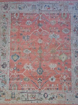 A close up of a rug with a floral pattern on it.