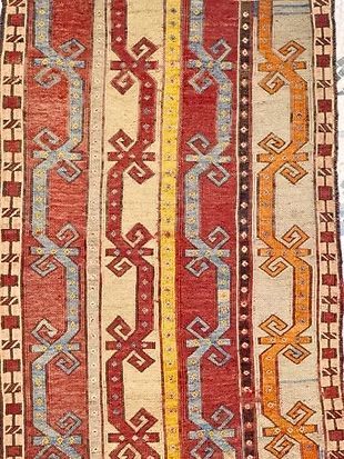 A close up of a rug with a geometric pattern on it.