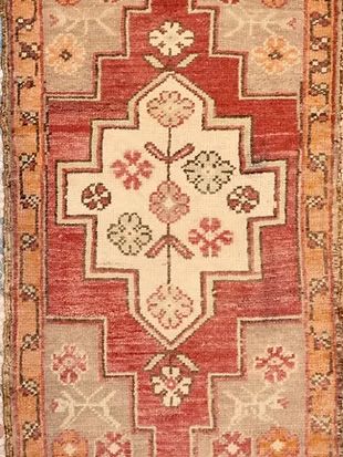 A close up of a rug with a floral pattern on it