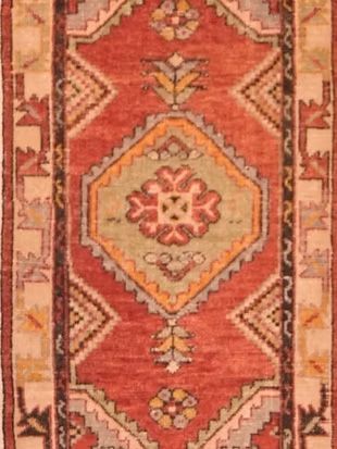 A red rug with a geometric pattern on it