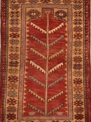 A red rug with a tree design on it