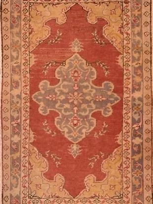 A red rug with a floral pattern on it