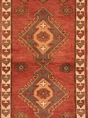 A close up of a rug with a geometric pattern on it